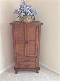 Dresser with cane accents. 24"W x 48"H x 16"D.