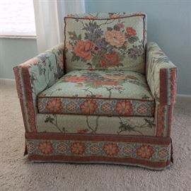 Upholstered chair with floral pattern. 