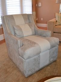 One of two Jessica Charles suede swivel chairs