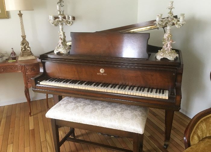 Schiller baby grand piano with upholstered bench. Piano was manufactured in 1936.