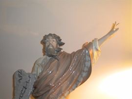 01001811 
MOSES & THE TEN COMMANDMENTS W/BOX Missing one finger
Issue Year: 1996 
Retirement Year: 2003 
Sculptor: Salvador Furió
Size: 21¼x11½ " 
Base included
Limited Edition 1200 pieces. This piece records the moment when Moses is given the ten commandments of God on Mount Sinai. The prophet is portrayed as quite elderly. He holds the commandments in his hand, while at his feet is the burning bush which revealed to him the name of Jehovah, God of his parents, as well as his mission to lead his people from Egypt's oppression and to Canaan. Listed at Replacements 1799.00 no box, ebay listed 2500.00 no box.