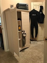Lovered door storage cabinet, wet suit.  Toaster oven