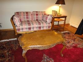 Carved coffee table, Plaid loveseat, 