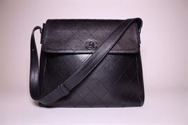 Chanel black flap bag with shoulder strap. Like new.  Retails $3500+. STARTING BID: $600 -- FIND MORE ITEMS ON OUR LIVE AUCTION WEBSITE! 