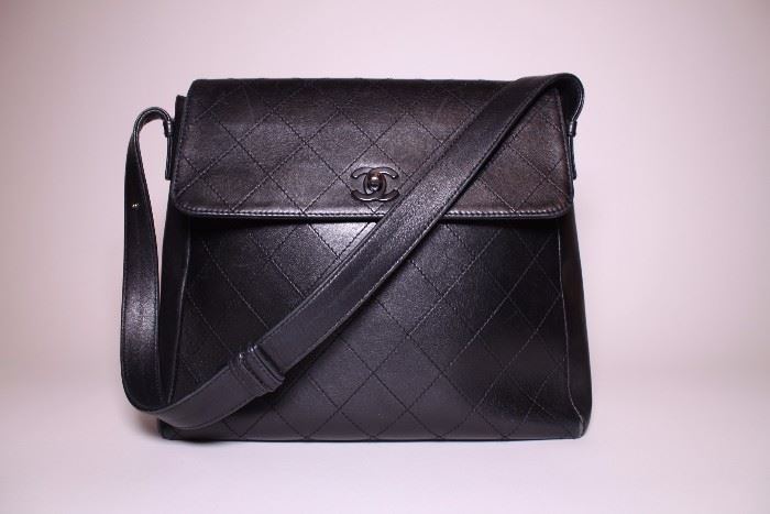 Chanel black flap bag with shoulder strap. Like new.  Retails $3500+. STARTING BID: $600 -- FIND MORE ITEMS ON OUR LIVE AUCTION WEBSITE! 