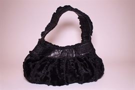 Dennis Basso black leather and fur handbag. Slightly used. Retails $250+. STARTING BID: $50 -- FIND MORE ITEMS ON OUR LIVE AUCTION WEBSITE! 