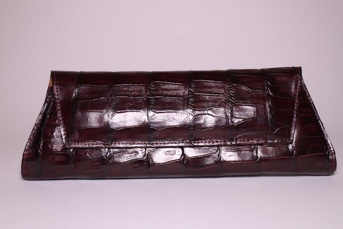 Tardini maroon alligator clutch. Like new. Retails $1750+. STARTING BID: $300 --- FIND MORE ITEMS ON OUR LIVE AUCTION WEBSITE!! 