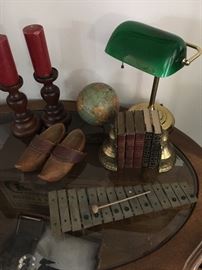 Xylophone, dutch shoes, hand blown bankers lamp on glass top coffee table