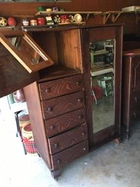 A quarter-sewn oak armoire chiffarobe on casters