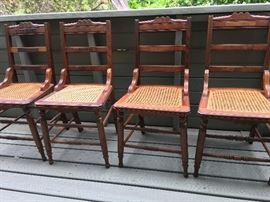 4 nearly identical caned side chairs. Can you spot the one that is different?