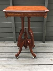 Solid walnut table with burl frieze on casters, in beautiful condition.