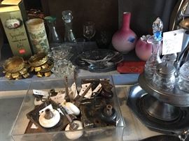 Clockwise from bottom: antique porcelain and glass doorknobs, antique locks and hardware, various brass etc candle votives, silver plate, Thomas Webb glass quilt vase (damaged) 1800's cruet set. (Garage)