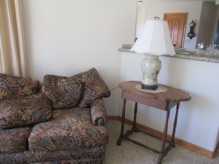 One of two couches, antique/vintage side table, lamp