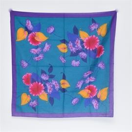 Christian Dior Cotton Scarf: A Christian Dior cotton scarf. The pattern features a teal ground with a violet border and a bold floral design in gold, rose, navy and violet to the center. It is marked “Christian Dior” to the bottom right.