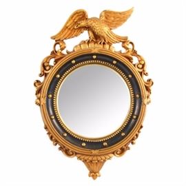 Syroco Wood Federal Style Convex Mirror: A vintage, federal style convex wall mirror by the Syracuse Ornamental Co. Inc. The frame is constructed from molded wood and applied with a gilt finish. It features an American Eagle cartouche, acanthus scrolls and lobed decoration to the bottom while a black painted interior border has studded embellishment. The backside panel is covered in brown felt with a ring hook for hanging and a manufacturer’s foiled sticker label is also retained on the reverse.