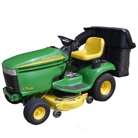 John Deere Tractor and Accessories: A John Deere tractor, model LX266 with accessories, including one rear bagger and power flow, a 42 inch front blade and a pair of wheel chains. Tractor features 16 HP and a two-wheel drive hydro transmission. Serial number on blade is MO2693X111867.