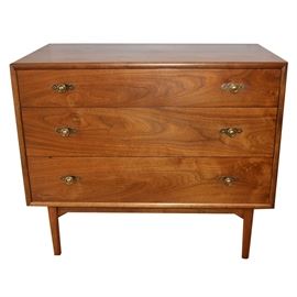 Mid Century Modern Three-Drawer Dresser by Drexel: A Mid Century Modern dresser by Drexel furniture. The dresser top and frame feature a beautiful natural walnut wood grain. Dresser includes three generous storage drawers with brass tone knobs and rests on four simple, rounded legs. The inside of the top drawer is hallmarked, Drexel. A companion hutch and dresser are available, items 17CIN187-043 and 17CIN187-055.