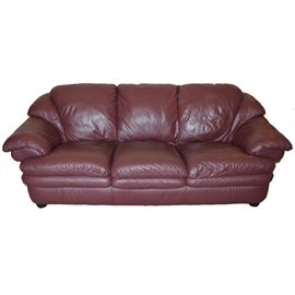 Plush Leather Sofa by Natuzzi: An ultra-plush leather sofa by Natuzzi. Sofa is upholstered in deep burgundy Italian leather and is presented in a contemporary frame. A matching companion chair and loveseat are available, item 17CIN187-044.