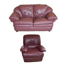 Italian Leather Loveseat and Recliner by Natuzzi: An ultra-plush leather loveseat and recliner by Natuzzi and eight throw pillows. Each piece is upholstered in deep burgundy Italian leather and is presented in a contemporary frame. The chair reclines with an easy-to-use right side pull lever. Eight throw pillows in a rust tone fabric are included. A matching companion sofa is available, item 17CIN187-045.