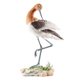 Numbered Boehm "American Avocet" Porcelain Figurine: A numbered porcelain American Avocet figurine by Boehm. This piece, style number 40134, is Issue Number 289. This elegant statuette depicts a long legged bird balanced on one leg. It is marked and numbered by the maker to underside. Boehm Porcelain was started by Edward Marshall Boehm (1913-1969), an American sculptor most known for the porcelain birds and wildlife sculptures he created, promoted by his equally well-known spouse, Helen Boehm. Together, the two founded E.M. Boehm Studios. Works created in the studio are in the Metropolitan Museum of Art, and the studio is known for its fine and elegant sculptural work owned by museums, royalty and celebrities worldwide.