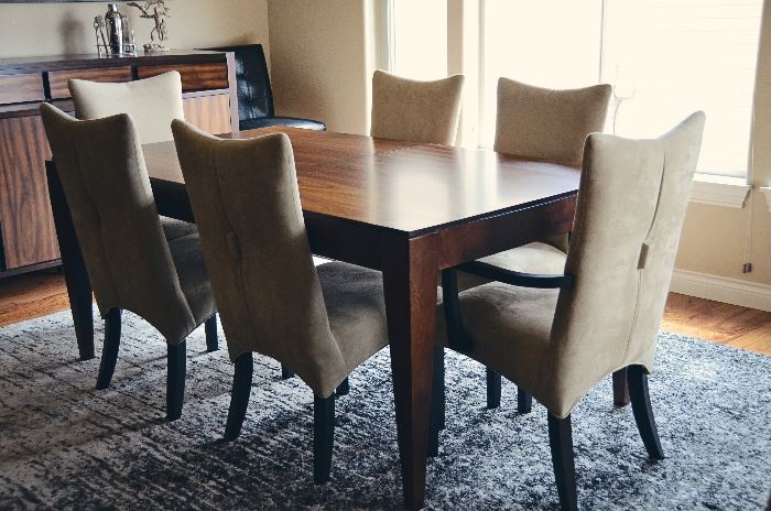 Beautiful rosewood dining table and buffet danish style, upholstered dining chairs with captain's chairs
(Wall hangings and rug not included)