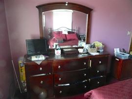 Very nice modern-style cherry dresser with mirror.  There are matching night stands.