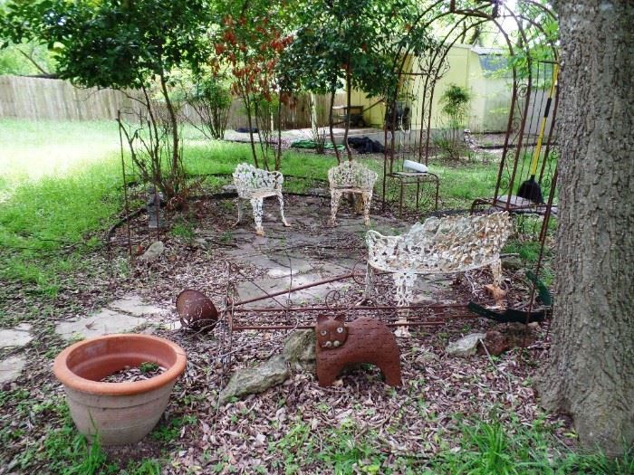 Arbors, cast iron furniture, pots and whimsical garden ornaments