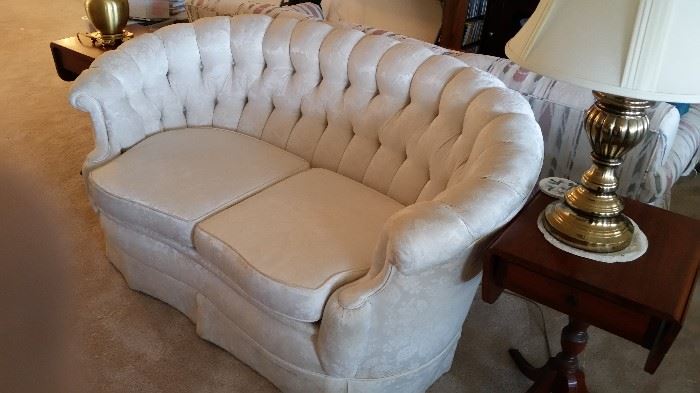  This gorgeous vintage tufted loveseat/settee has a divine curved frame.