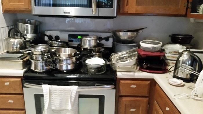 Lots of pots and pans and kitchen items.