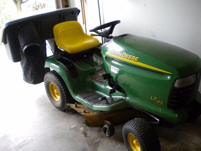 John Deere riding mower LT150 with accessories and pull behind trailer sold separately.