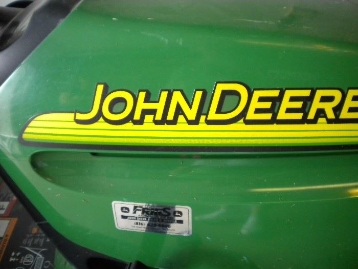 John Deere riding mower LT150 with accessories and pull behind trailer sold separately.