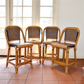French Bistro Stools: A set of four French bistro chairs. These classic stools have wood frames and feature a chevron pattern in natural rattan and navy blue.