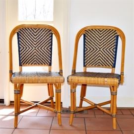 French Bistro Chairs: A set of 2 French bistro style chairs. These classic chairs have wood frames and a chevron pattern in natural rattan and navy blue.