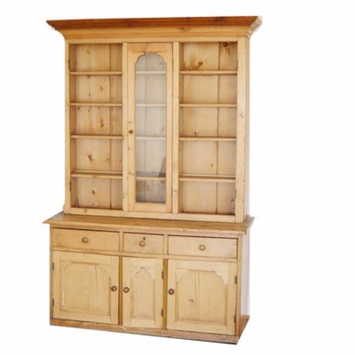 French Pine Hutch: A French pine hutch. This classic hutch features a top piece, that comes apart from the base, that has three sections for storing china. Each section has five shelves and glass doors. The doors have been removed from the side shelves but are included with the sale of this piece. The bottom has three drawers and three cabinets for storage.