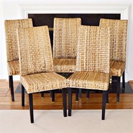 Seagrass Dining Chairs: A set of 6 seagrass dining chairs. These tall back woven chairs are made of a honey colored seagrass, with naturally occurring color variations, and black wooden legs.