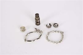 Sterling Silver Jewelry Assortment: A sterling silver jewelry assortment. This assortment features two bracelets, one band ring , earrings and a small glass perfume bottle framed in pierced sterling silver cover. All items marked 925. Total weight 3.191 ozt. Sterling bottle frame and bottle not weighed.