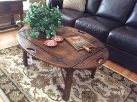 Leather sofa, vintage oval table with hinged sides that fold up