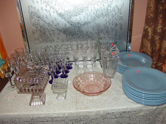 Large assortment of wine glasses and set of blue Fiesta plates and soup bowls