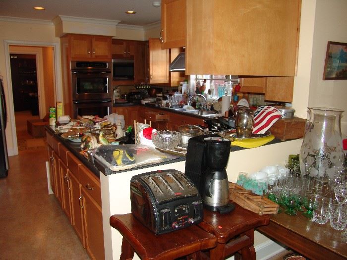 Large kitchen packed with cookware and glassware including some Fire King wares