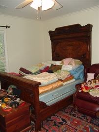 Edwardian era walnut bed, Circa 1900 and leather recliner