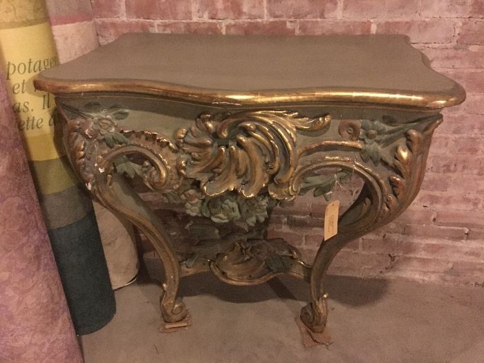 Very rare & early Rococo console table, circa 1770. Very richly carved, gilt wood. Cabriole legs. Wide apron with richly carved, having character of 'rocaille'. Top in painted marble-effect wood. Secondary gilding, marbling. Very good quality craftsmanship