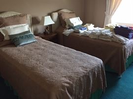 Twin beds with wicker headboard, mattresses included, almost new. 
