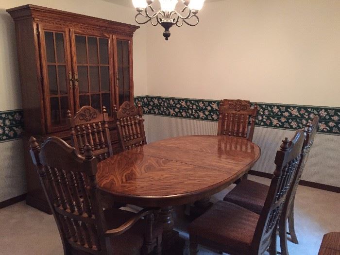 Solid oak dining room table and china cabinet.
