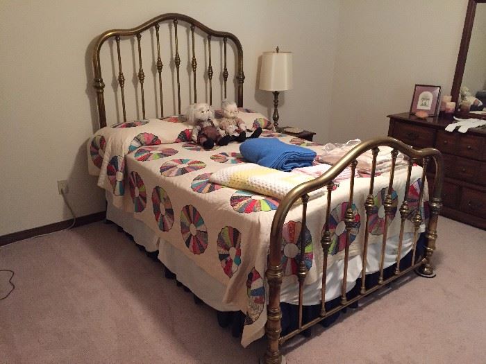 Solid brass double bed with mattress and box springs.