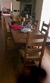 Wonderful strong dining table and 6 matching chairs with rush seats. 