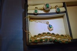 One 14k yellow gold emerald cut emerald diamond ring. The center stone measures 7 X 5.11 mm and weighs approximately 1.2 carats and is AA quality. The diamonds are I1 to I2 and J color. The center stone is enhanced by 36 melle diamonds approximate total diamond weight is .61 carats.