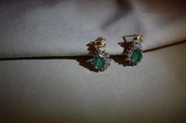 One pair 14k yellow gold pear shaped emerald and diamond earrings. Emeralds are 7 X 5mm and AA quality. Encircled by 14 round diamonds and accented at the top with a row of baggett diamonds. 