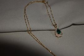 14k yellow gold pear shaped emerald and diamond pendant. The emerald is 8 X 6 mm approximately 1.4 carats AA quality. The emerald is enriched by round diamonds approximately 2.0 carats total. These diamonds are I1 - I2 clarity and I - J color. 