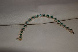 14k yellow gold pear shaped emerald and diamond bracelet. Consists of 19 links each containing one pear shaped emerald approximately 6 X 4 mm and 11 round diamonds. The emeralds are AA quality and set in 3 prongs. The diamonds are 11 - 12 clarity and J color approximate 2.1 carat weight. Approximate carat weight of the emeralds is 12.35.