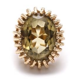 14K Yellow Gold Citrine Ring: A 14K yellow gold ring features a multi-pronged crown that holds a faceted oval citrine.